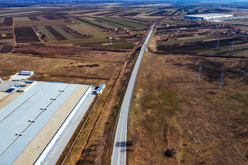 Fototapeta premium Aerial view of industrial estate surrounded by cultivated field