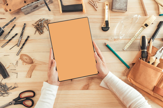 Female carpenter using digital tablet computer, mock up screen
