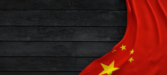 Flag of China, fabric on dark wood.