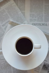 cup of coffee on newspaper background