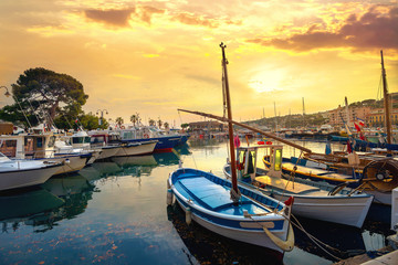 Landscape with fishing boats in harbour of Cassis at sunset. France, Provence