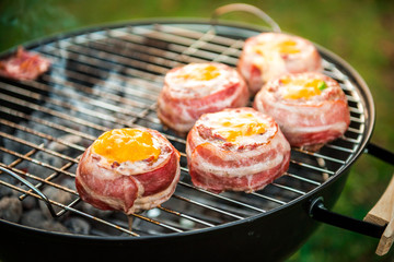 Making home made Beer Can Bacon Burgers on barbecue grill.