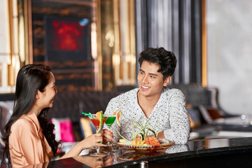 Couple sitting at bar counter