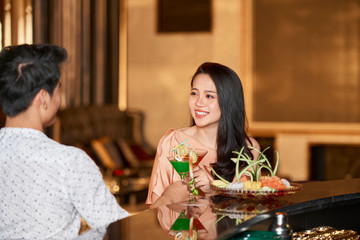 Young couple drinking cocktails