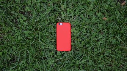 Red iPhone on grass