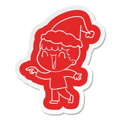 laughing cartoon  sticker of a man pointing wearing santa hat