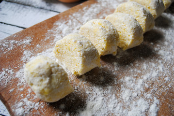 Dough for cheesecakes on the kitchen table