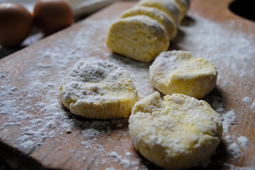Dough for cheesecakes on the kitchen table