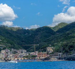 Fototapeta premium Italy, Cinque Terre, Monterosso, a large body of water with a mountain in the background