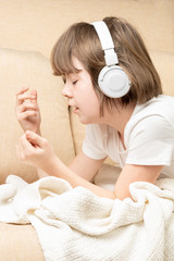 Teen girl listening music with the bluetooth headphones