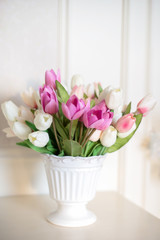 Beautiful bouquet of white and purple tulips in a bright room