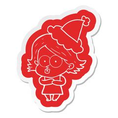 cartoon  sticker of a girl pouting wearing santa hat