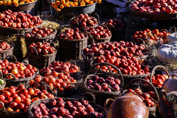 Autumn harvest. Apples in wooden baskets lit by the morning sun.