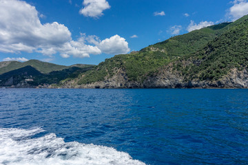 Italy, Cinque Terre, Monterosso, a large body of water with a mountain in the background