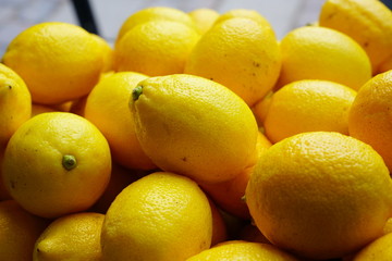 Fresh ripe yellow lemons at the market