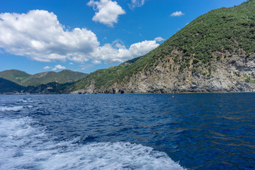 Fototapeta na wymiar Italy, Cinque Terre, Monterosso, a large body of water with a mountain in the background
