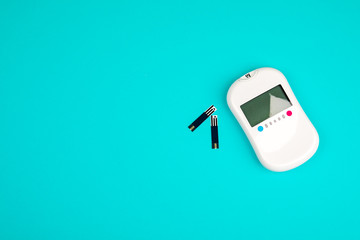 Diabetes. Diabetes concept. Glucose meter and injections for insulin on a blue background. Diabetic supplies.