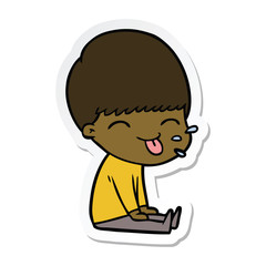 sticker of a cartoon boy sticking out tongue