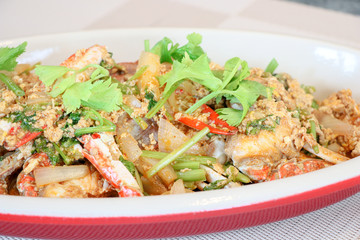 Close up of blue crab dish with yellow curry sauce mix with eggs, curry plate, fish sauce, palm sugar, chili, onion, green celery, one of the most delicious seafood in Thailand.      