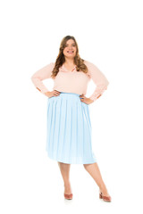 smiling happy overweight woman in elegant clothing posing with hands on hips isolated on white