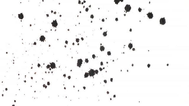 Multiple abstract dots of ink appearing on white background. Top view footage. Perfect elements for your creative projects.
