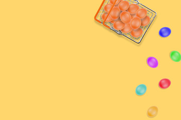 One full glossy metal market basket of fresh raw brown eggs on yellow table on kitchen. Top view. Business concept. Copy space for your text