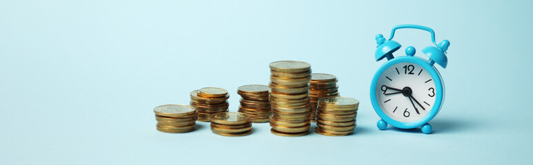 Time is money concept. Alarm clock and golden coins. Financial option of cash investment.
