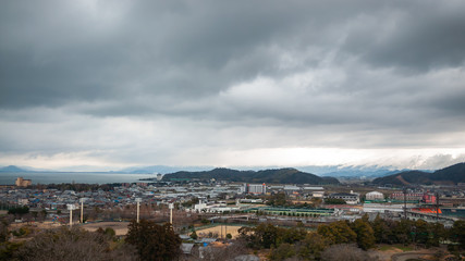 Panoramic, scenic landscape view with beautifully textured clouds that can be seen from Hikone Castle, located in the city of Hikone in Shiga Prefecture, Japan.