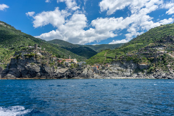 Fototapeta premium Italy, Cinque Terre, Monterosso, a large body of water with a mountain in the background