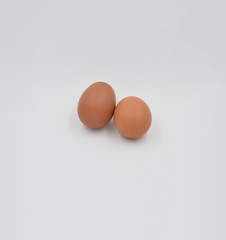 Two  brown eggs together on the grey background