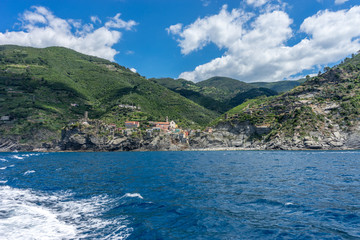 Italy, Cinque Terre, Monterosso, a large body of water with a mountain in the background