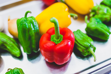 colorful bell peppers on metal background