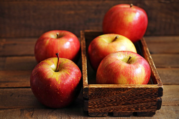 Fresh red apples on wood