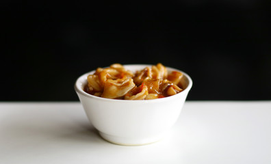 Cumi Saus Padang or Squid in Padang Sauce on black background. Spicy food from Padang, West Sumatra, Indonesia. 