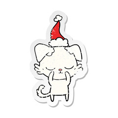 cute distressed sticker cartoon of a dog wearing santa hat