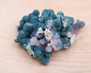 Grape Agate Clusters from Indonesia isolated on natural wooden background.