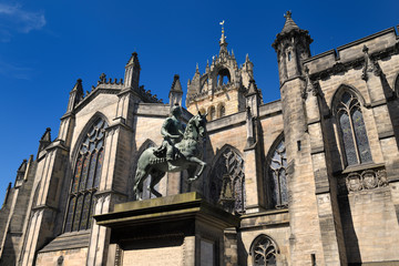 Fototapeta na wymiar Bronze sculpture of Charles II on horseback at south side of St Giles' Cathedral with crown steeple Edinburgh Scotland United Kingdom