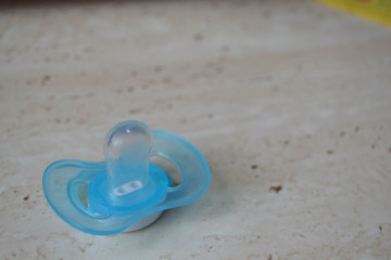 Fototapeta na wymiar Blue baby pacifier