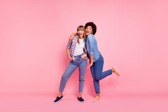 Full length body size view portrait two funky diversity she her ladies posing photo set open mouth emotionally good mood wear casual jeans denim checkered shirt clothes outfit isolated pink background