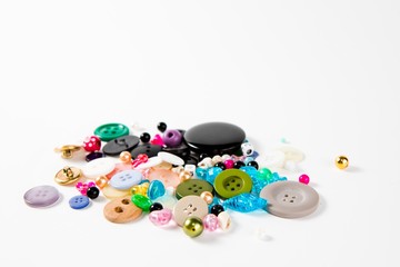 Pile of tailor's knobs of many sizes. shapes and colors.