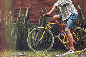 Naklejka premium Attractive man standing with old bicycle.