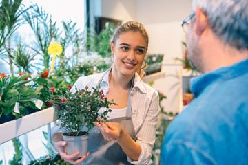 florist selling flower to a customer