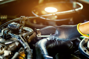 Auto mechanic Preparing For the work. Mechanic with Stainless Steel Wrench in Hand.Close up of hands mechanic doing car service and maintenance.Engine Maintenance concept