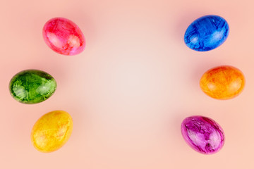 Colored Easter eggs on pink background.