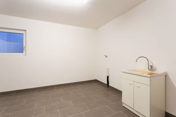 Cellar with gray tiles and white walls