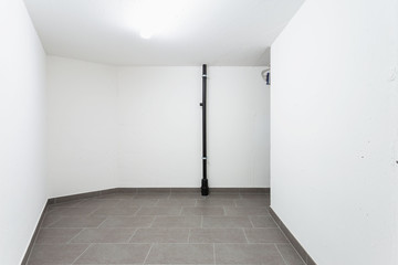 Cellar with gray tiles and white walls