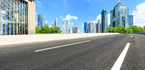 Fototapeta premium Asphalt road and modern city commercial building scenery in Shanghai