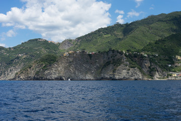 Italy, Cinque Terre, Monterosso, a large body of water with a mountain in the background