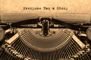 Everyone Has a Story printed on a sheet of paper on a vintage typewriter. writer, journalist.