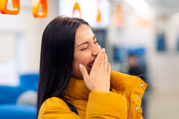 Positive young female in public transport, bus, tram, trolley bus.